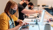 Warhammer Fest painting station with masked attendees